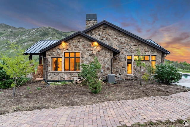 370 S Got Teeth Ln E, Emigration Canyon, UT 84108 - view of front of house with stone siding, a chimney, a standing seam roof, and a metal roof