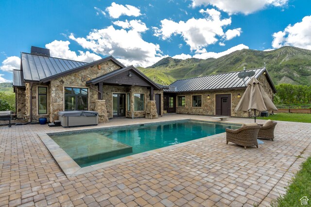 370 S Got Teeth Ln E, Emigration Canyon, UT 84108 - swimming pool with a hot tub, a mountain view, a patio area, and a diving board