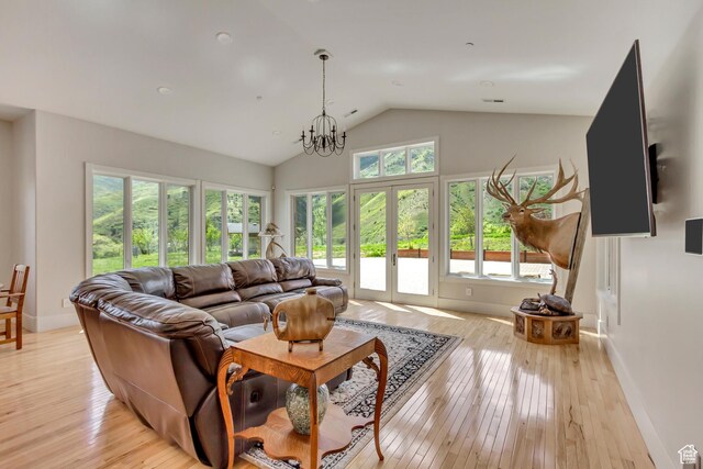 370 S Got Teeth Ln E, Emigration Canyon, UT 84108 - living room featuring lofted ceiling, light wood-style floors, french doors, and a chandelier