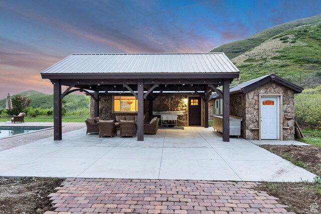 370 S Got Teeth Ln E, Emigration Canyon, UT 84108 - patio terrace at dusk with a gazebo, outdoor lounge area, a patio area, and an outdoor pool