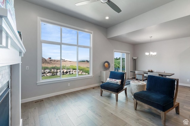 1308 E Daffodil Ct Unit 150, Layton, UT 84040 - sitting room featuring a fireplace, ceiling fan, a chandelier, light wood finished floors, and recessed lighting