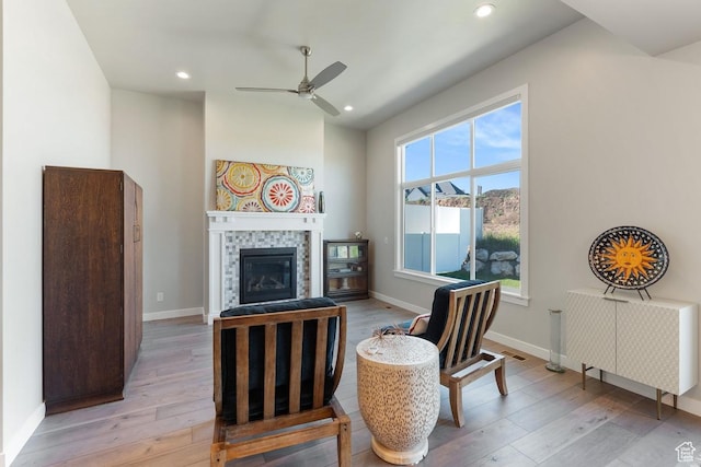 1308 E Daffodil Ct Unit 150, Layton, UT 84040 - living room with light wood-style flooring, ceiling fan, a tiled fireplace, and recessed lighting