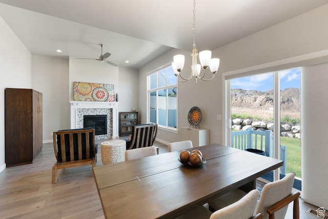 1308 E Daffodil Ct Unit 150, Layton, UT 84040 - dining room featuring light wood-type flooring, ceiling fan, a tile fireplace, a chandelier, and recessed lighting