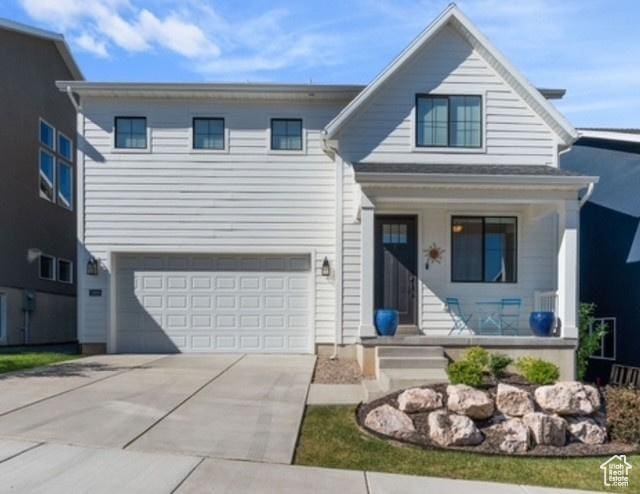 1308 E Daffodil Ct Unit 150, Layton, UT 84040 - view of front of house featuring covered porch, an attached garage, and driveway