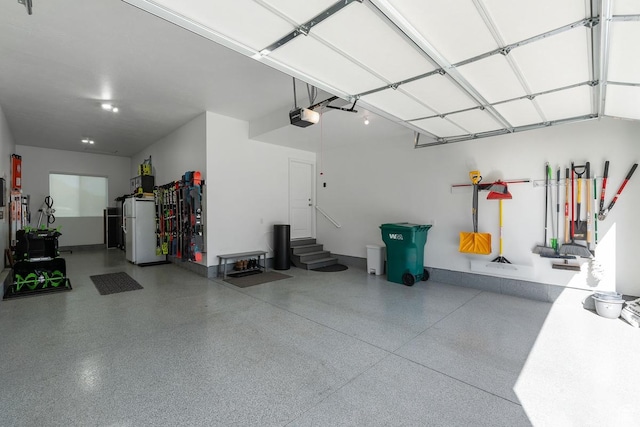 1308 E Daffodil Ct Unit 150, Layton, UT 84040 - garage featuring refrigerator and a garage door opener