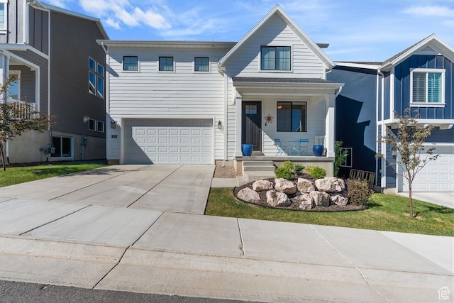 1308 E Daffodil Ct Unit 150, Layton, UT 84040 - view of front facade featuring a porch, an attached garage, and concrete driveway