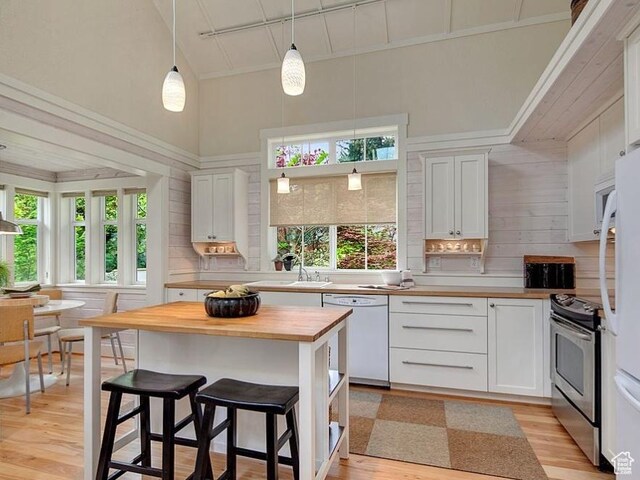 247 W 200 S, Santaquin, UT 84655 - kitchen featuring white appliances, wood counters, light wood finished floors, white cabinetry, and high vaulted ceiling