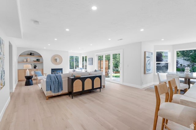 2795 E Palma Way, Cottonwood Heights, UT 84121 - living area featuring light wood-style floors, recessed lighting, built in features, and a glass covered fireplace