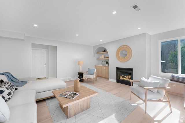 2795 E Palma Way, Cottonwood Heights, UT 84121 - living room featuring light wood-style floors, a glass covered fireplace, recessed lighting, and built in features