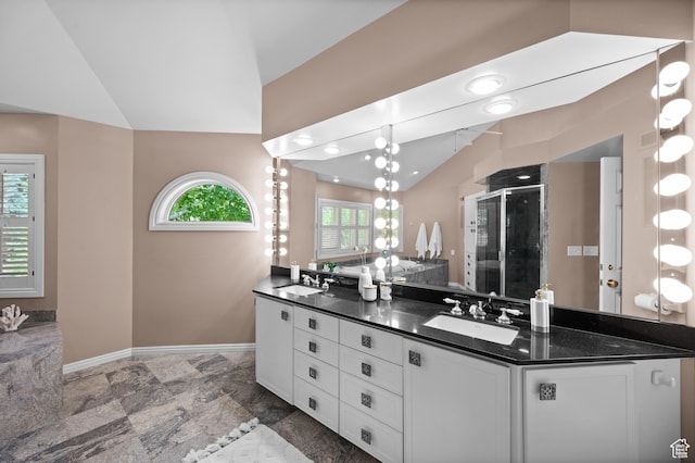 5757 S Holladay Blvd E, Holladay, UT 84121 - full bath featuring lofted ceiling, double vanity, a stall shower, and stone finish floors