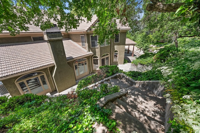 5757 S Holladay Blvd E, Holladay, UT 84121 - view of front facade with a tile roof, stucco siding, and a patio area