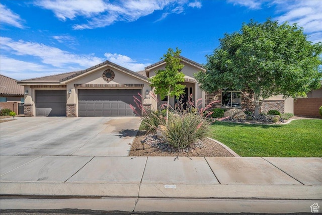 3075 E Delany Dr, St George, UT 84790 - view of front of property featuring stucco siding, driveway, an attached garage, a front yard, and stone siding
