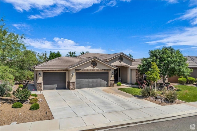3075 E Delany Dr, St George, UT 84790 - ranch-style home with stucco siding, a garage, stone siding, concrete driveway, and a tiled roof