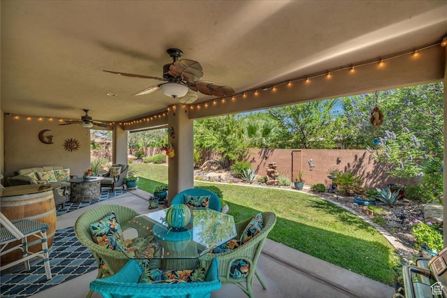 3075 E Delany Dr, St George, UT 84790 - fenced backyard featuring a ceiling fan, an outdoor hangout area, a patio, and outdoor dining space