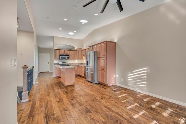 9656 Villa Springs Cv, Sandy, UT 84070 - kitchen featuring stainless steel appliances, a ceiling fan, a kitchen island, wood finished floors, and high vaulted ceiling