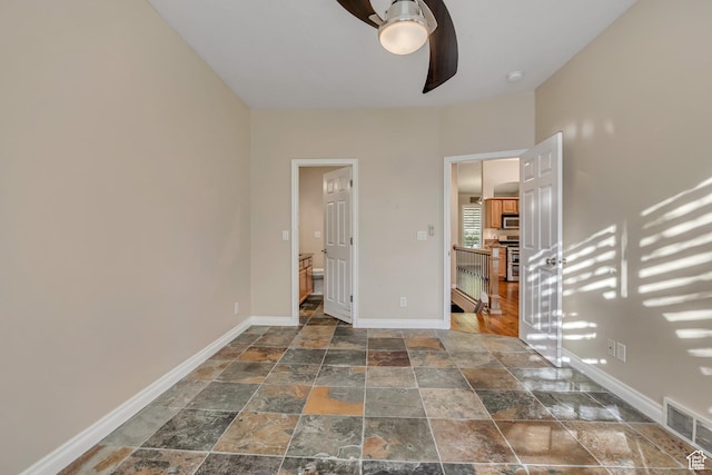 9656 Villa Springs Cv, Sandy, UT 84070 - unfurnished bedroom featuring stone tile floors and baseboards