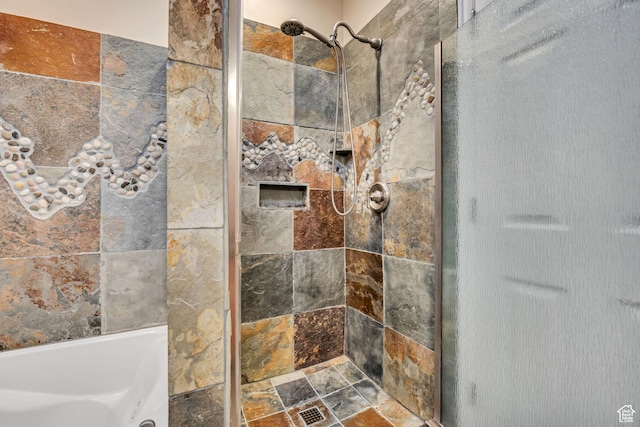 9656 Villa Springs Cv, Sandy, UT 84070 - bathroom featuring a tile shower and stone finish flooring