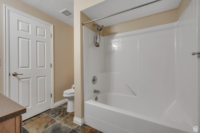 9656 Villa Springs Cv, Sandy, UT 84070 - bathroom featuring shower / tub combination, vanity, and stone finish flooring
