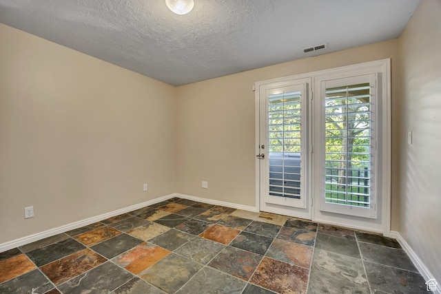 9656 Villa Springs Cv, Sandy, UT 84070 - spare room featuring stone tile floors and a textured ceiling