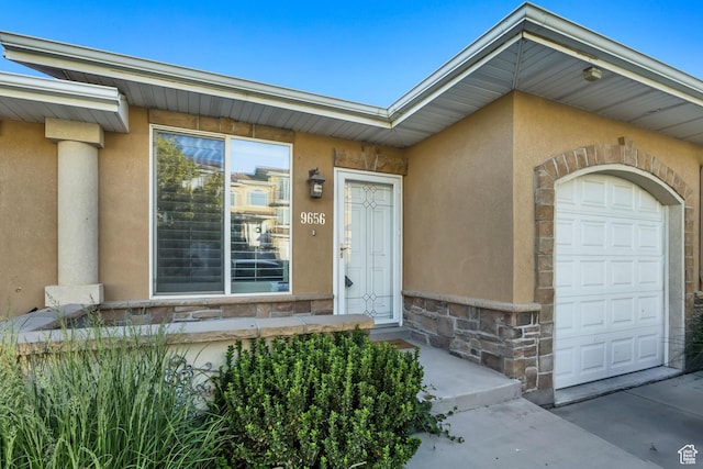 9656 Villa Springs Cv, Sandy, UT 84070 - entrance to property featuring stucco siding, stone siding, and an attached garage