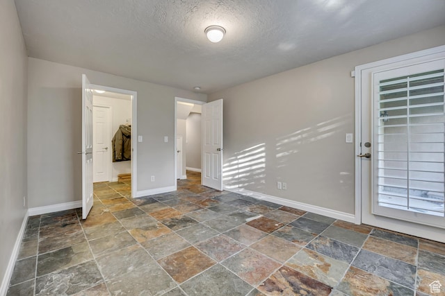 9656 Villa Springs Cv, Sandy, UT 84070 - spare room featuring stone tile flooring and a textured ceiling