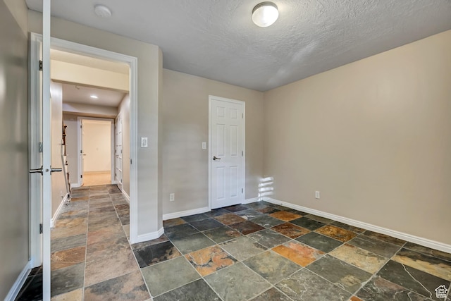 9656 Villa Springs Cv, Sandy, UT 84070 - unfurnished room featuring stone tile flooring, a smoke detector, and a textured ceiling