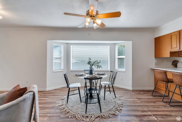 2522 N 1000 E, Provo, UT 84604 - dining space featuring crown molding, a ceiling fan, light wood-type flooring, and a textured ceiling