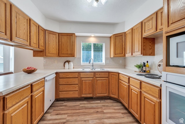 2522 N 1000 E, Provo, UT 84604 - kitchen featuring white appliances, light wood-type flooring, backsplash, light countertops, and brown cabinets