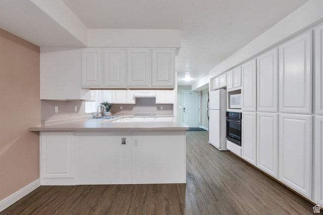 2522 N 1000 E, Provo, UT 84604 - kitchen with white appliances, light countertops, a peninsula, and dark wood finished floors