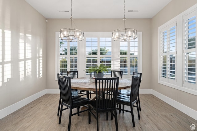 2530 S Monterosa Ln, St George, UT 84790 - dining area with a chandelier, plenty of natural light, and light wood-style flooring