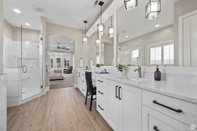 2530 S Monterosa Ln, St George, UT 84790 - ensuite bathroom with ceiling fan, vanity, a shower stall, wood finished floors, and recessed lighting