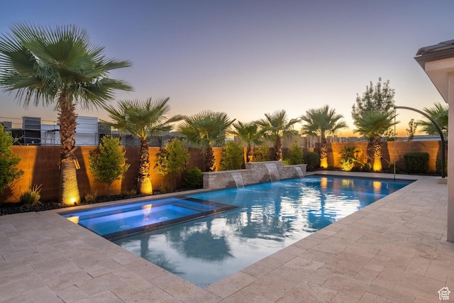 2530 S Monterosa Ln, St George, UT 84790 - pool at dusk with a fenced backyard, a pool with connected hot tub, and a patio area
