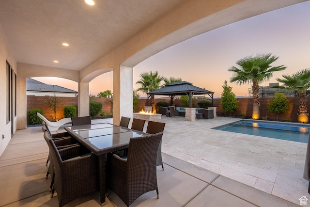 2530 S Monterosa Ln, St George, UT 84790 - fenced backyard featuring a patio area, an outdoor living space with a fire pit, outdoor dining area, and a gazebo
