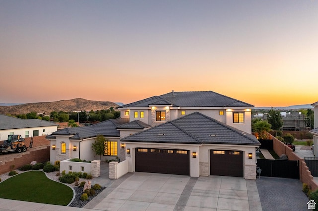 2530 S Monterosa Ln, St George, UT 84790 - view of front of house with an attached garage, concrete driveway, a mountain view, stucco siding, and a tile roof