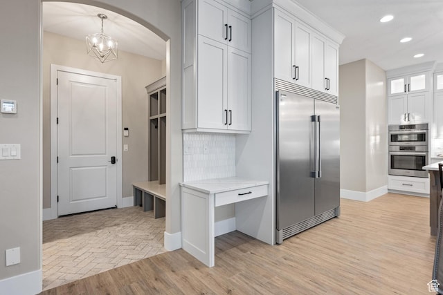 2530 S Monterosa Ln, St George, UT 84790 - mudroom featuring arched walkways, recessed lighting, a chandelier, and light wood finished floors
