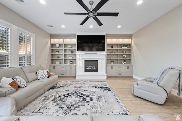 2530 S Monterosa Ln, St George, UT 84790 - living area with ceiling fan, a glass covered fireplace, recessed lighting, and light wood finished floors
