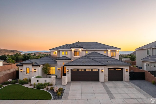 2530 S Monterosa Ln, St George, UT 84790 - view of front of house with a garage, driveway, stucco siding, stone siding, and a tile roof