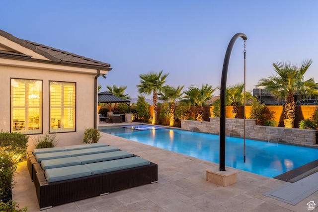 2530 S Monterosa Ln, St George, UT 84790 - pool at dusk featuring outdoor lounge area, a patio, and a fenced backyard