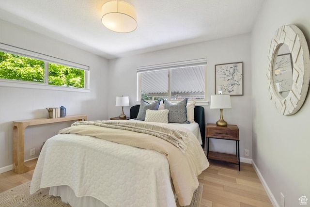 1876 E Northwoodside Dr S, Holladay, UT 84124 - bedroom with light wood-type flooring and baseboards