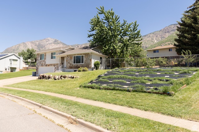 2908 N Cherry Dr E, North Ogden, UT 84414 - tri-level home with stone siding, a mountain view, concrete driveway, and an attached garage