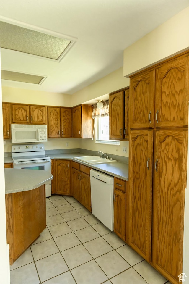 2908 N Cherry Dr E, North Ogden, UT 84414 - kitchen featuring white appliances, brown cabinets, light countertops, and light tile patterned floors