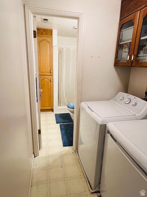 2908 N Cherry Dr E, North Ogden, UT 84414 - laundry room with washer and dryer, light flooring, and cabinet space