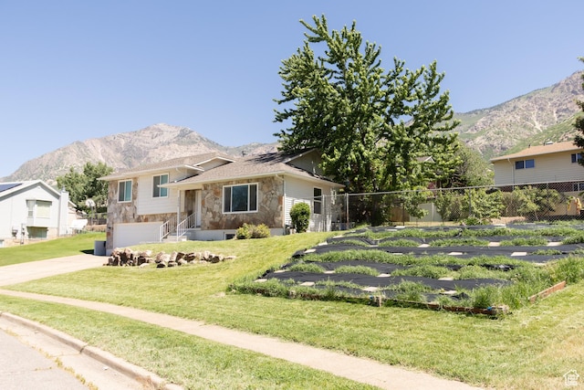 2908 N Cherry Dr E, North Ogden, UT 84414 - split level home featuring stone siding, a mountain view, driveway, and an attached garage