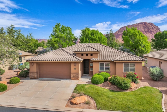 336 W 270 S, Ivins, UT 84738 - mediterranean / spanish house featuring a mountain view, stucco siding, a garage, and concrete driveway