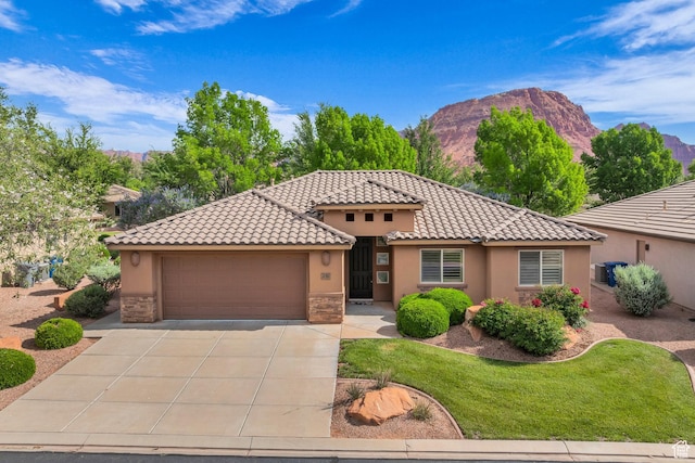 336 W 270 S, Ivins, UT 84738 - mediterranean / spanish-style home featuring stucco siding, a garage, a mountain view, driveway, and stone siding