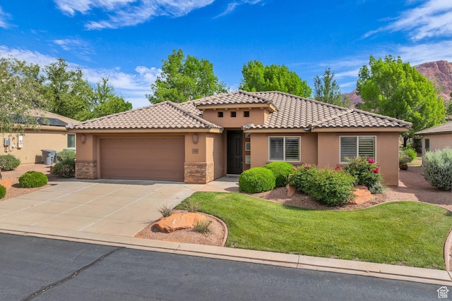 336 W 270 S, Ivins, UT 84738 - mediterranean / spanish house featuring an attached garage, stucco siding, concrete driveway, and a tile roof