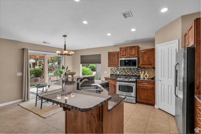 336 W 270 S, Ivins, UT 84738 - kitchen with appliances with stainless steel finishes, brown cabinets, backsplash, a breakfast bar, and recessed lighting