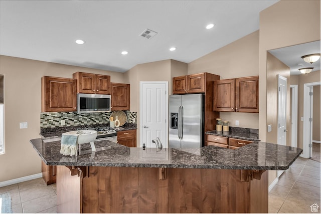 336 W 270 S, Ivins, UT 84738 - kitchen featuring stainless steel appliances, a breakfast bar area, light tile patterned floors, tasteful backsplash, and vaulted ceiling