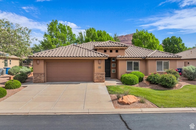 336 W 270 S, Ivins, UT 84738 - mediterranean / spanish house featuring stone siding, stucco siding, a tiled roof, and an attached garage