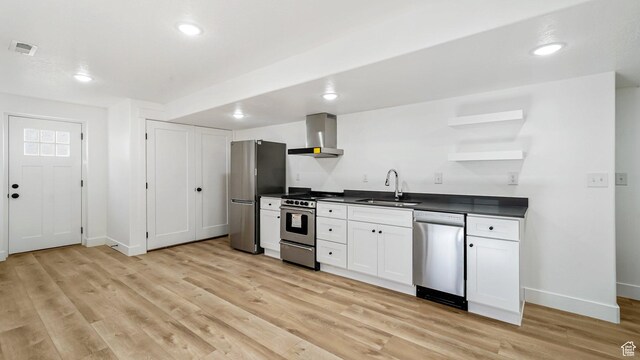 312 N 240 E, Vineyard, UT 84059 - kitchen with appliances with stainless steel finishes, wall chimney exhaust hood, open shelves, dark countertops, and light wood-style flooring